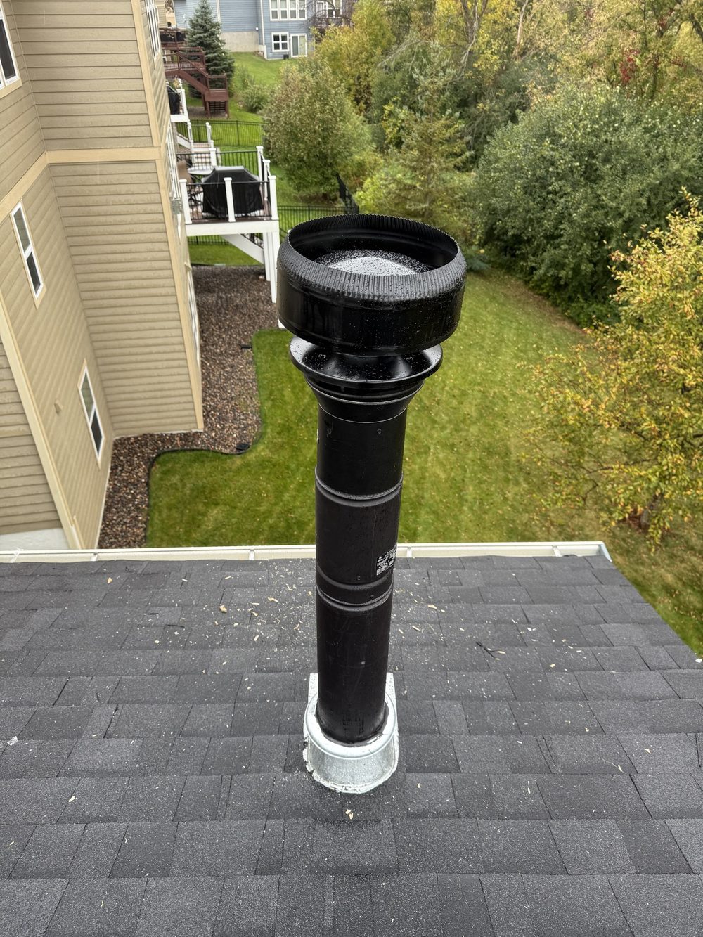 New stainless flue pipe and cap on a wood stove install. Chimney Liner Installation by Chimney & Home Improvement, Twin Cities MN.